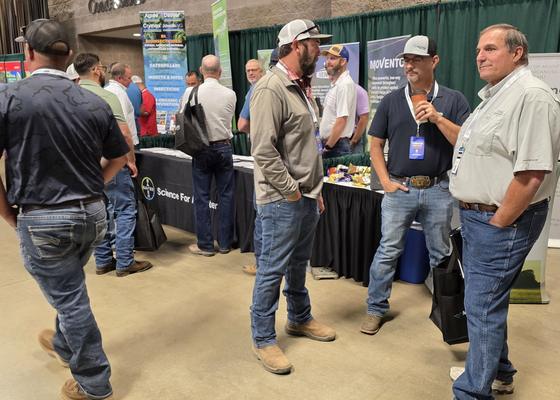 Attendees talking and laughing on the trade show floor