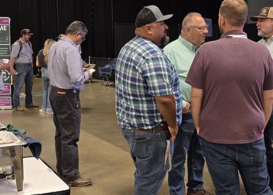 Attendees comparing notes on Day 2