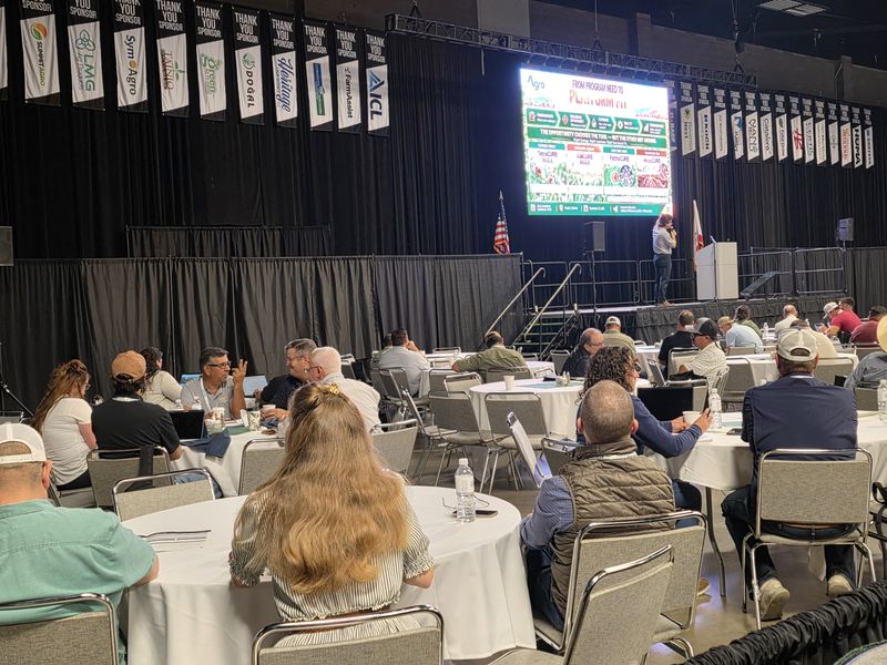 Attendees at full tables in the Expo Hall during a Day 1 morning session