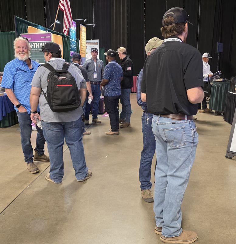 Attendees in conversation on the trade show floor