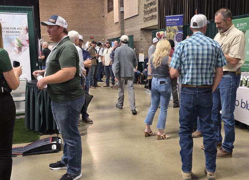 Attendees talking in a busy trade show aisle