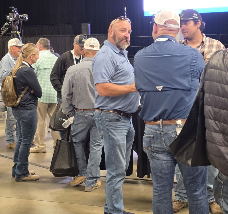 Attendees gathered in conversation near the stage area