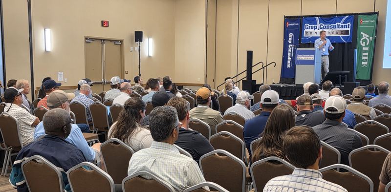 Rows of attendees filling a breakout room in front of the Crop Consultant Conference stage
