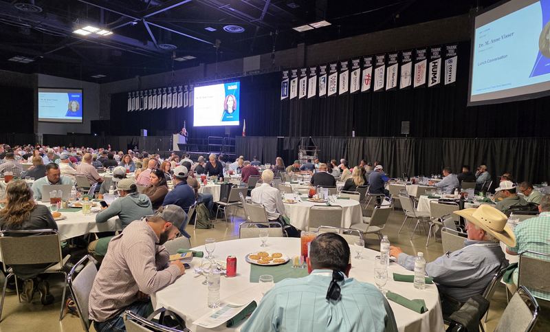 A packed Expo Hall of round tables during the Day 1 lunch talk