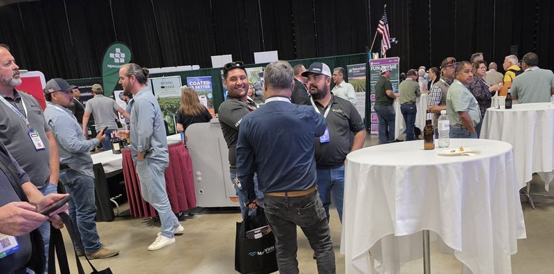 A crowd at high-top tables during the Day 1 mixer