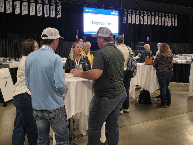 Attendees at the Day 1 mixer, with AgroSpheres on the screen behind them