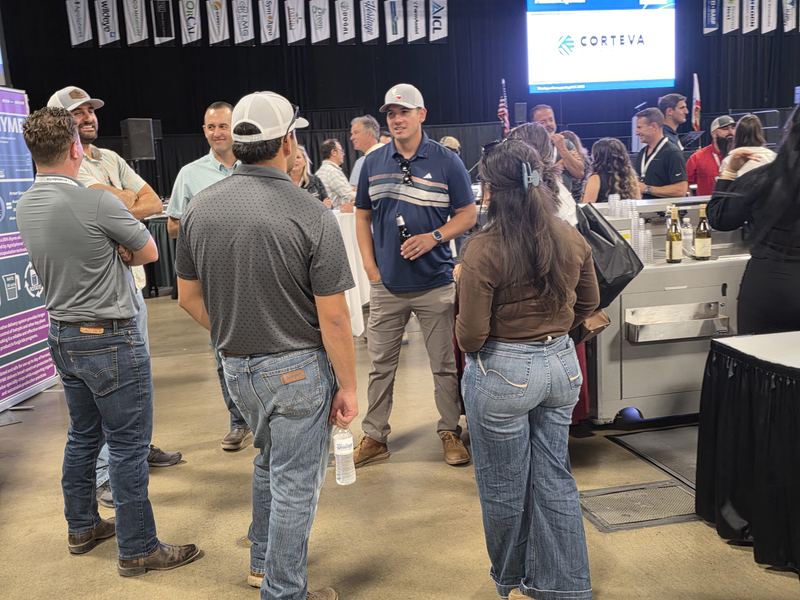 Attendees at the end of the Day 1 mixer, with Corteva on the screen