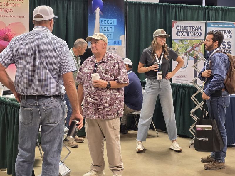 A group of attendees laughing together near a booth