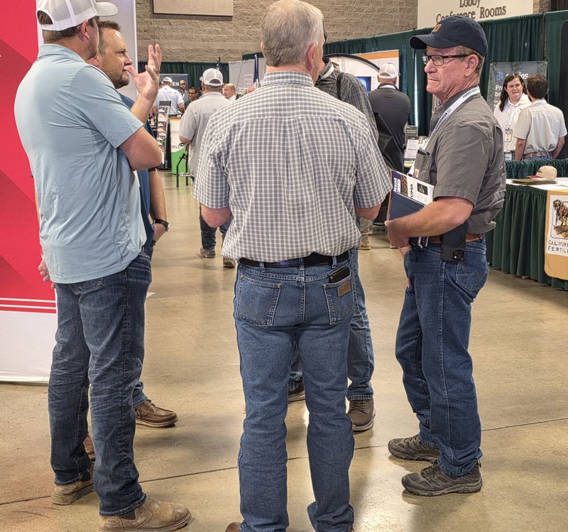 Three attendees talking on the trade show floor