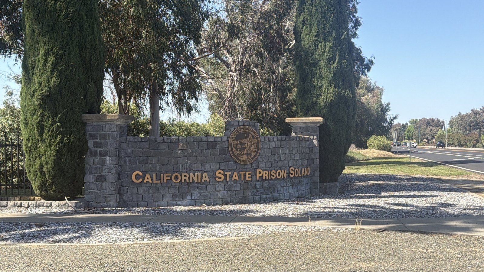 A stone monument sign reading "California State Prison Solano" at the facility's entrance in Vacaville, California