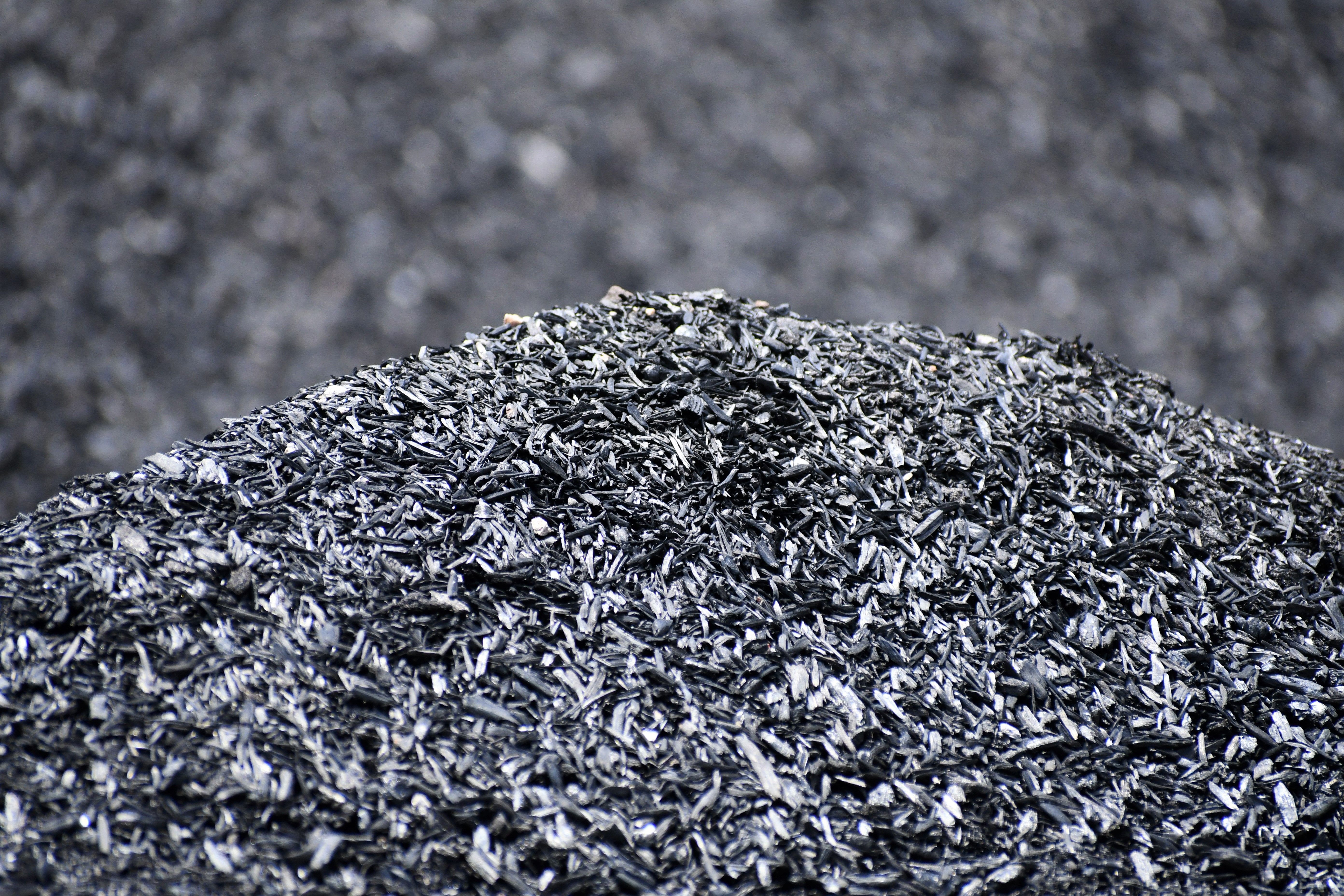 A pile of biochar made from almond shells showing the porous structure that retains water and supports microbial life